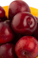 Red round plum on white background