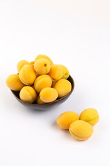 Yellow apricots on white background