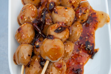 Meatballs with spicy dipping sauce in white plates, Thai street food