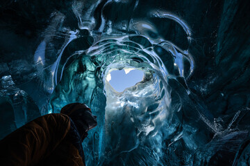 Explorer in the blue ice caves in J&ouml;kuls&aacute;rl&oacute;n glacier, Iceland, North Atlantic Ocean
