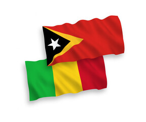 National vector fabric wave flags of East Timor and Mali isolated on white background. 1 to 2 proportion.
