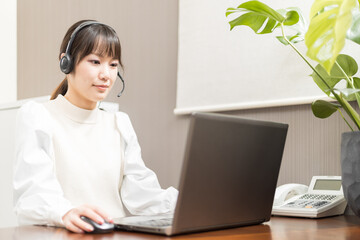 Woman wearing a headset and having a web conference