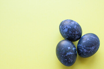 Easter eggs lie on a yellow background