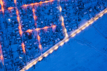 Low-rise suburban buildings, drone view. Night winter cityscape.