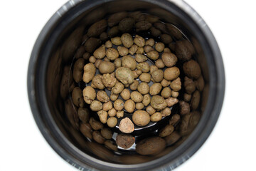Expanded clay for drainage of plants in a black pot.