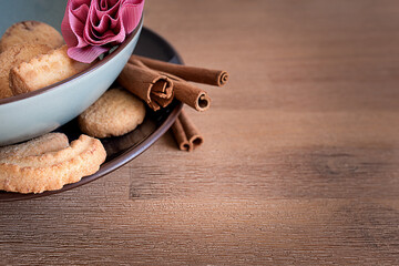 cookies on a plate with cinnamon sticks