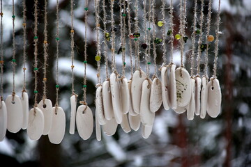 Hand made wind chimes hanging on a string with depth of field effect. Ceramic wind chime hanging...