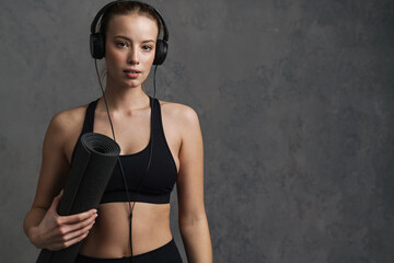 Young athletic woman in wireless headphones