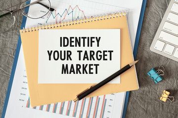 Identify Your Target Market is written in a document on the office desk