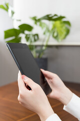 Woman sitting in a chair and holding a tablet