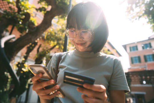 Young adult business asian woman consumer using creadit card and smartphone for shopping online.
