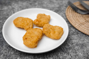 Selective focused Nuggets on white dish.