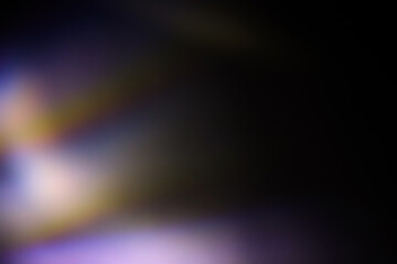 Blur colorful rainbow light leaks on black background. Defocused illuminated abstract retro film effect texture for using over photos as overlay or screen filter