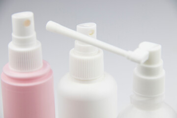 cosmetic bottles with a spray bottle on a white background. medicine bottles, disinfection bottles with spray guns