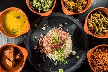 An assortment of Sri Lankan dishes and red rice.