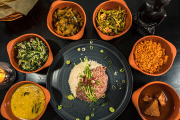 An assortment of Sri Lankan dishes and red rice.
