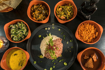 An assortment of Sri Lankan dishes and red rice.