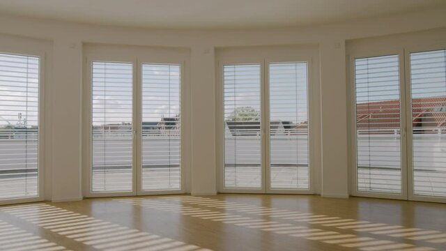 window blinds open and close while panning in an empty apartment