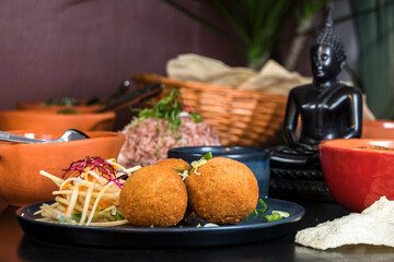 A Sri Lankan dish of fish cutlet balls and papadam bread.