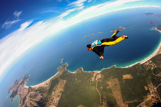 Skydiving Wing Suit Flying Over Brazilian Beach