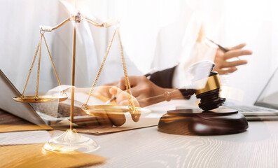 Justice and law concept.Male judge in a courtroom with the gavel, working with, computer and...