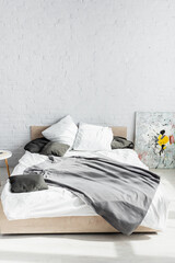 Grey blanket and pillows on bed at home