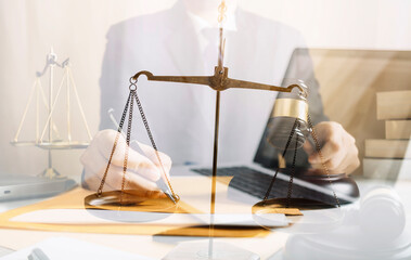 Justice and law concept.Male judge in a courtroom with the gavel, working with, computer and...
