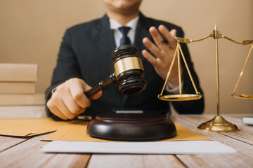Business and lawyers discussing contract papers with brass scale on desk in office. Law, legal...