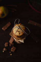 Chocolate and hazelnuts chip homemade cookies with hot cacao and dark and moody still life with apples