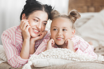 Mother and daughter having fun at home. Girls indoors.