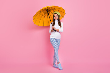 Full length body size view of lovely cheerful girl holding in hands parasol walking isolated over...