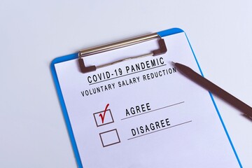 Checklist attached on blue clip board and pen - Agree of voluntary salary reduction 