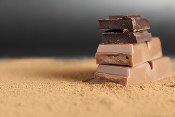 Chocolate Day Holiday and dark chocolate lies a stack of slides on top of each other against a backdrop of cocoa and a black background with room for text copyspace