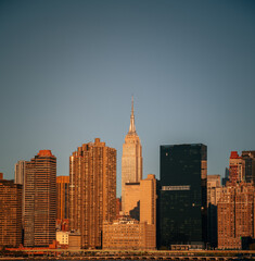Fototapeta na wymiar reflections sun sunrise new york city skyscrapers offices buildings apartments urban area sky 