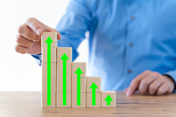 Businessman hand with blocks stacking in step stair.  Concept for investment strategy, business, success and stock portfolio.