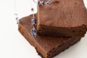 Lavender brownie chocolate brown cake. Sweet lavender dessert on white background.
