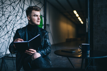 Fototapeta premium Confident guy doing sketch sitting in cafe