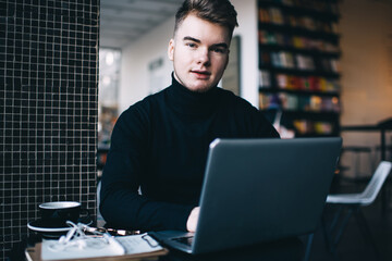 Man using laptop for browsing while having break in library