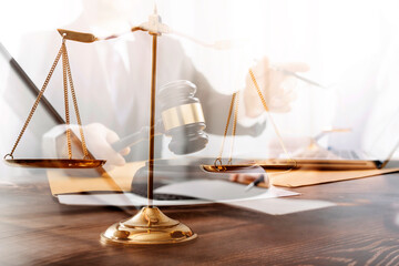 justice and law concept.Male judge in a courtroom on wooden table and Counselor or Male lawyer...