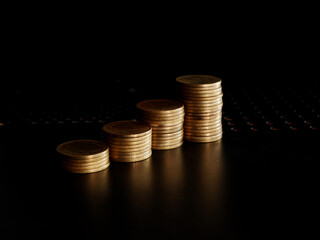 stacks of gold coin on black background concept saving money