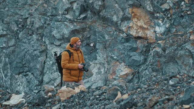 Photographer in the mountains in 4k UHD