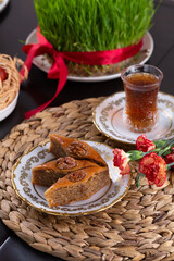 Novruz pastry pakhlava, Azerbaijan national holiday, ethnic cuisine eastern desserts for spring equinox celebration in white and golden plate. Persian nooruz sweets, copy space   