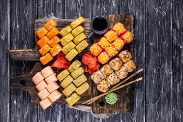 Fresh sushi rolls on wooden board. Traditional Japanese food. Dinner party.