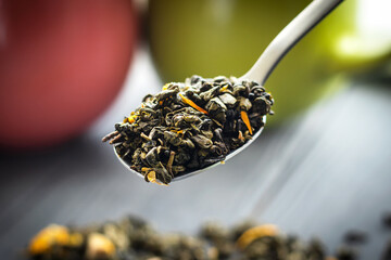 Fototapeta na wymiar dry tea in metal spoon closeup