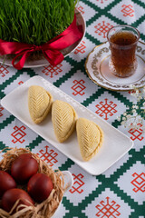 Novruz pastry shakarbura, Azerbaijan national holiday, ethnic cuisine eastern desserts for spring equinox celebration in white plate. Persian nooruz sweets, copy space   