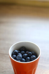 Bowl of blueberries on a table. Selective focus.