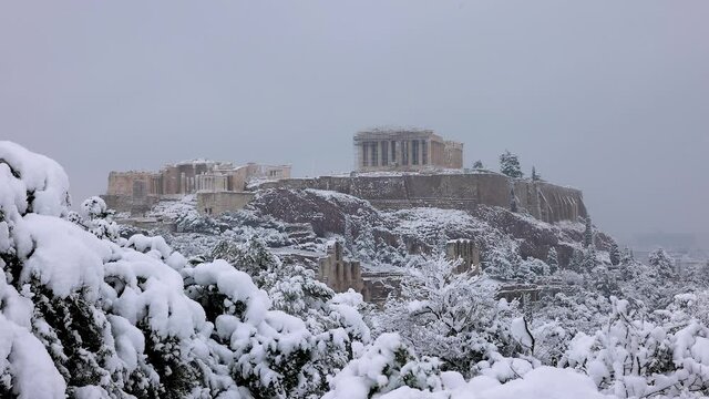 Closeup view to the Parthenon Temple at the Acropolis of Athens, Greece, with heavy snowfall during winter time