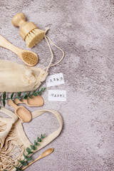 Zero Waste Eco Friendly Concept Background with Bathroom and Kitchen Accessories and Eco Bag on Concrete Background Vertical Copy