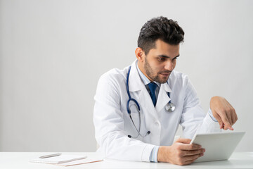 Young arab internist using tablet computer