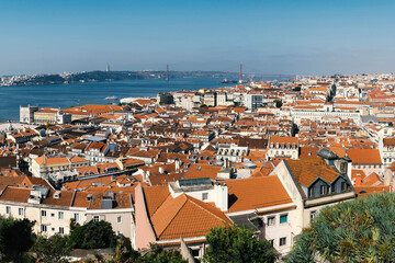 Fototapeta na wymiar A panoramic view over Lisbon with beautiful reed roofs and river Tejo in summer sunlight.